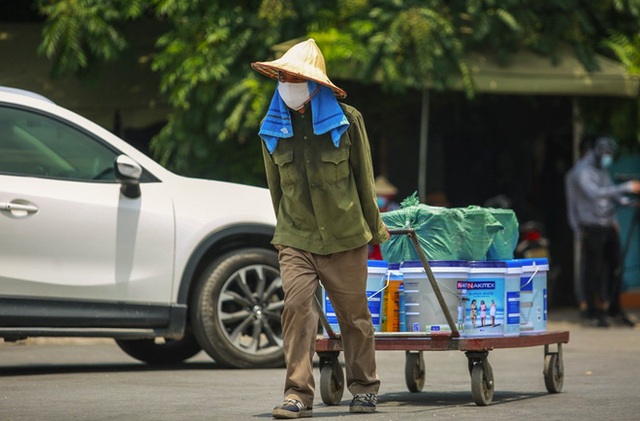 Nắng nóng đỉnh điểm lên đến gần 50 độ C tại Hà Nội: Mặt đường bốc hơi, người dân chật vật mưu sinh - Ảnh 8.